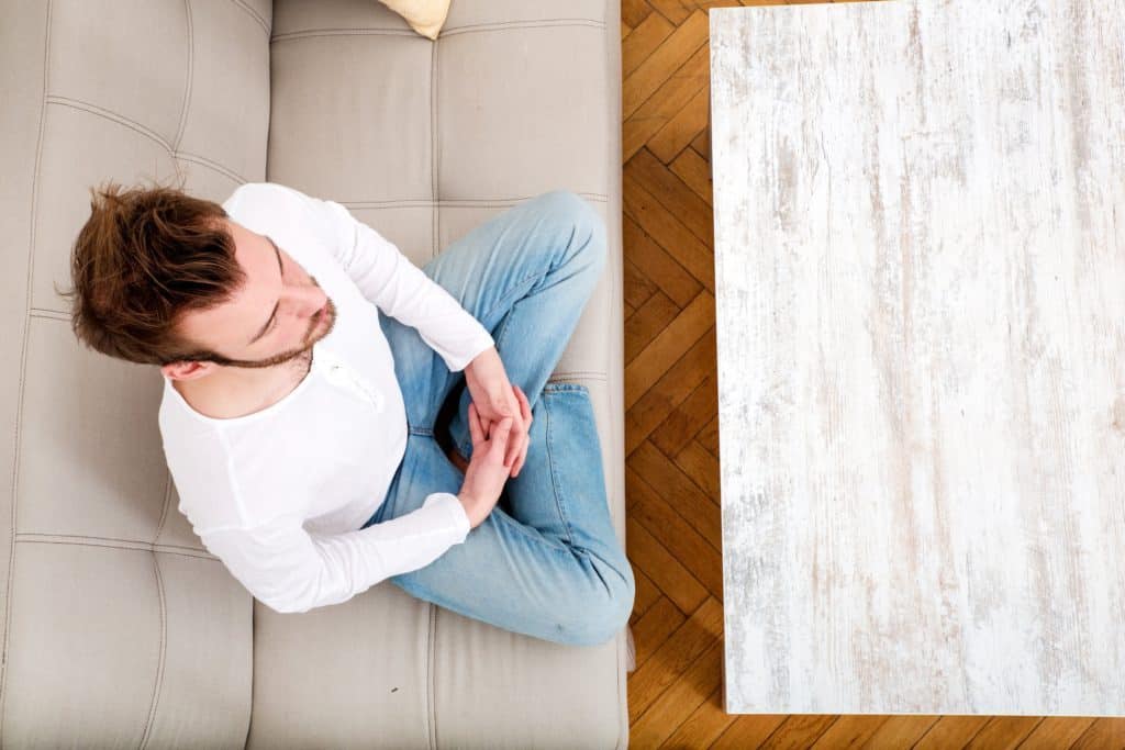 top down picture of man sitting and practicing mindfulness