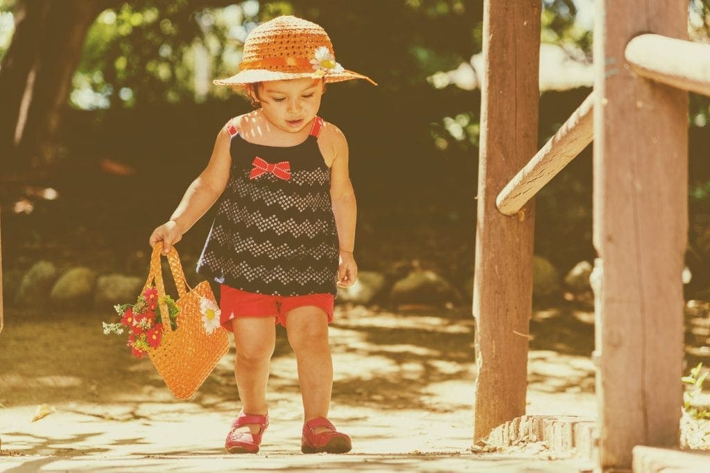 mindful game for toddlers walking outside and observing nature while gathering flowers