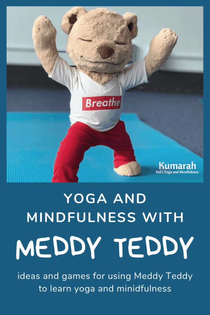 Meddy Teddy doing warrior one pose on a yoga mat in a classroom