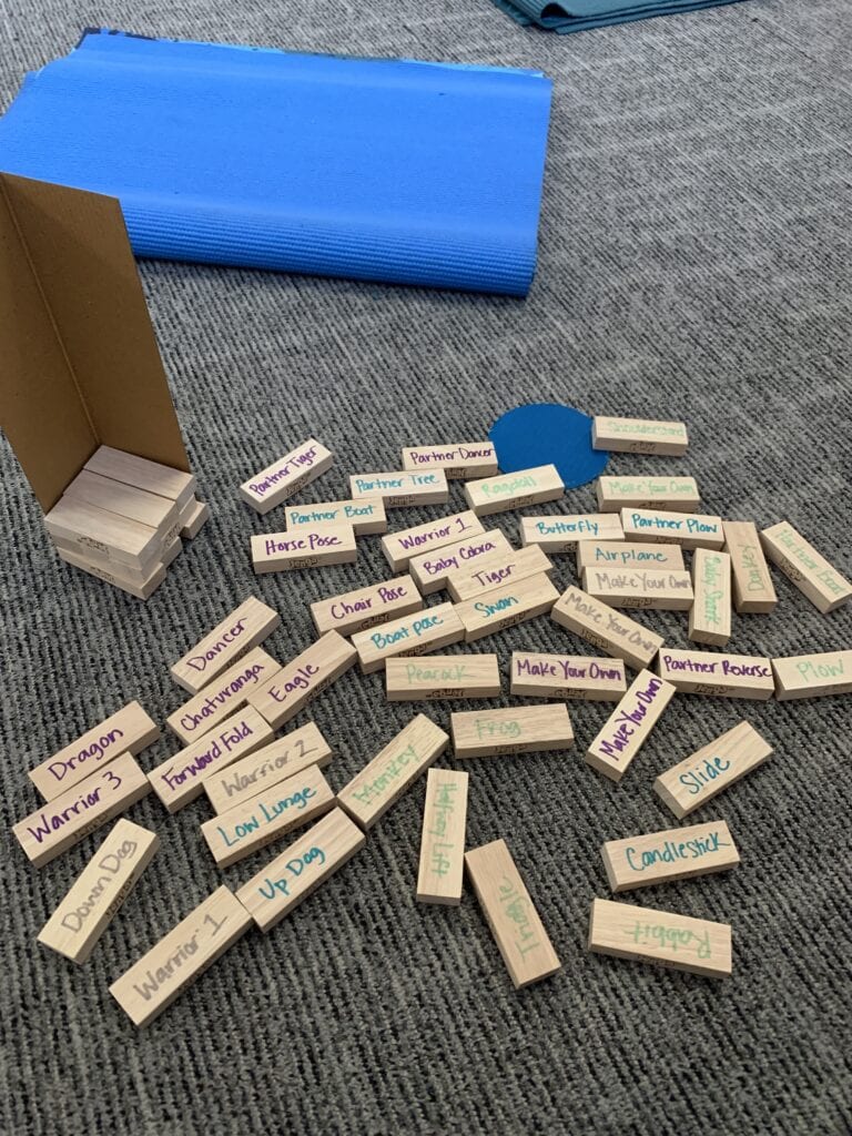 yoga jenga, yoga for kids at home, yoga games at home, jenga blocks with yoga poses written on the side