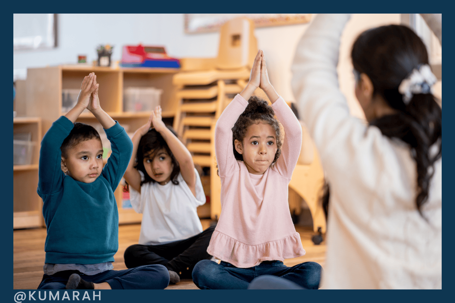 children doing yoga breathing with teacher