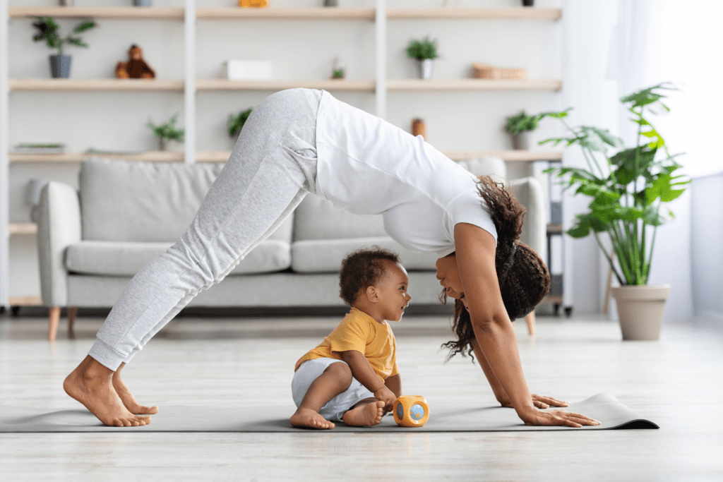 toddler doing yoga with parent at home